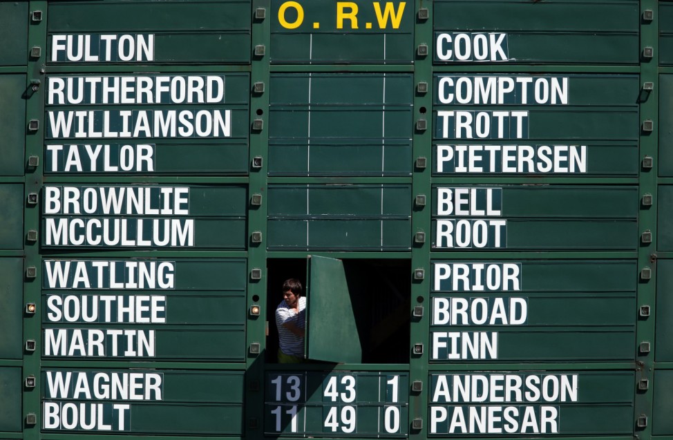 A worker looks out from the scoreboard displaying the players names for the England and New Zealand teams during the first day of the second test at the Basin Reserve in Wellington