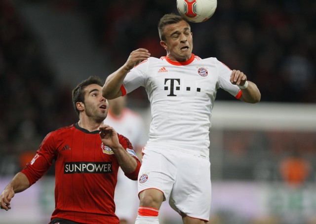 Ramos of Bayer Leverkusen looks on as Bayern Munich's Shaqiri jumps for a header during their German first division Bundesliga soccer match in Leverkusen