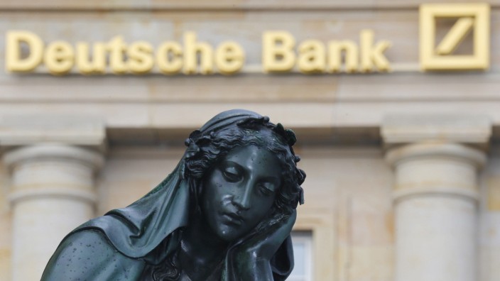 A statue is pictured in front of the former head quarters of Germany's largest business bank, Deutsche Bank in Frankfurt
