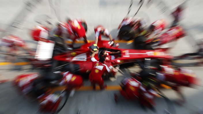 Ferrari Formula One pit crew practice pit stop with Felipe Massa's car at the Sepang International Circuit