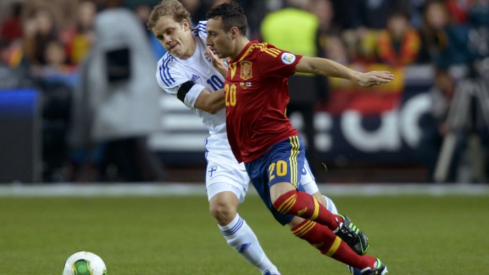 Finland's Pukki challenges Spain's Cazorla Gonzalez during their 2014 World Cup qualifying soccer match in Gijon