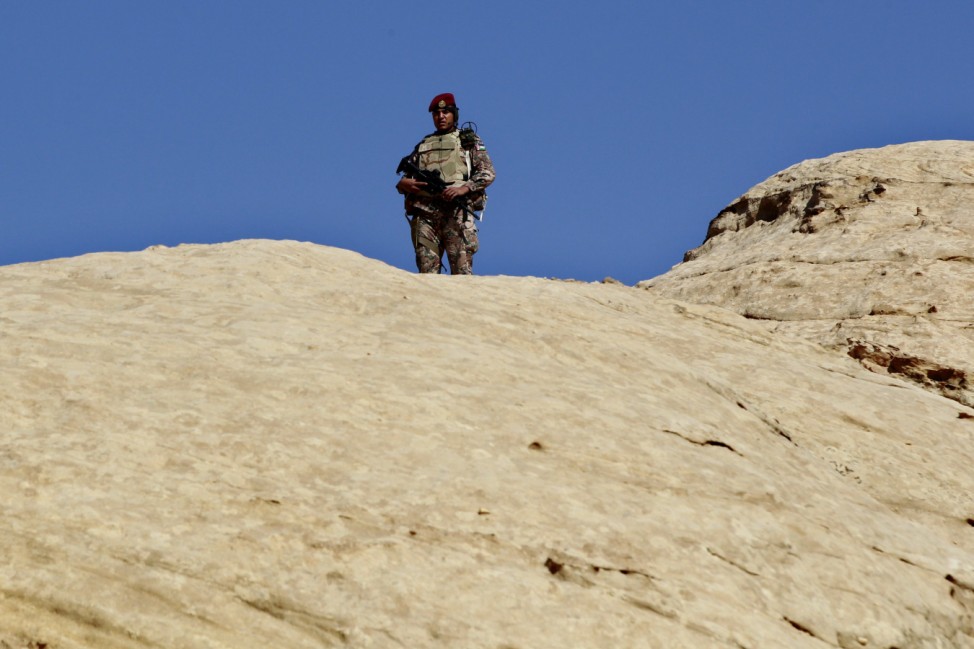 A Jordanian soldier stands among the rocky landscape before U.S. President Barack Obama participates in a walking tour of Petra