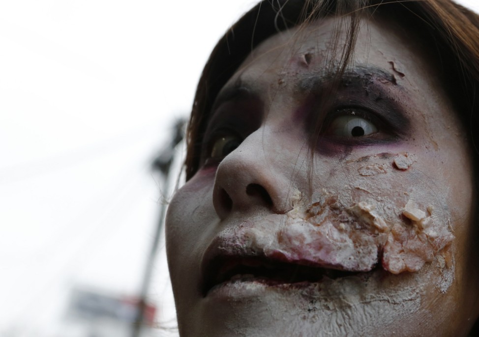 An office worker, who is dressed as a zombie, poses for a photo before the Roppongi Zombie Walk in Tokyo