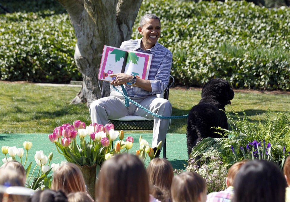 Obama reads the children's book 'Chicka Chicka Boom Boom' to children during the 135th annual Easter Egg Roll on the South Lawn of the White House in Washington