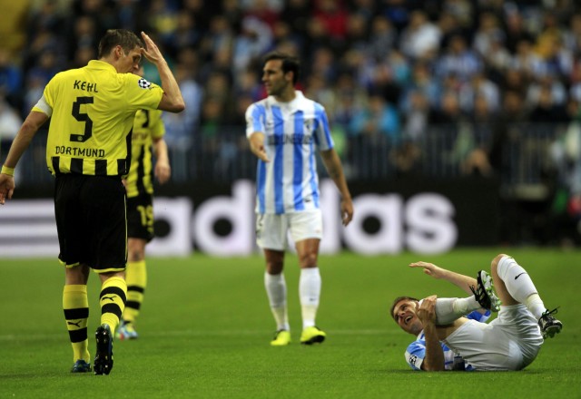 Borussia Dortmund's Kehl gestures at Malaga's Joaquin as he lies on the pitch during their Champions League quarter final first leg soccer match at La Rosaleda stadium in Malaga