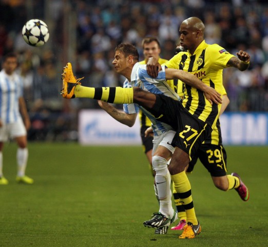 Borussia Dortmund's Santana challenges Malaga's Joaquin during their Champions League quarter final first leg soccer match at La Rosaleda stadium in Malaga