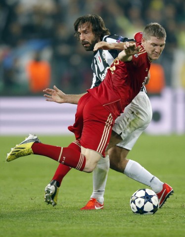 Bayern Munich's Schweinsteiger is challenged by Pirlo of Juventus during their Champions League quarter-final second leg soccer match in Turin