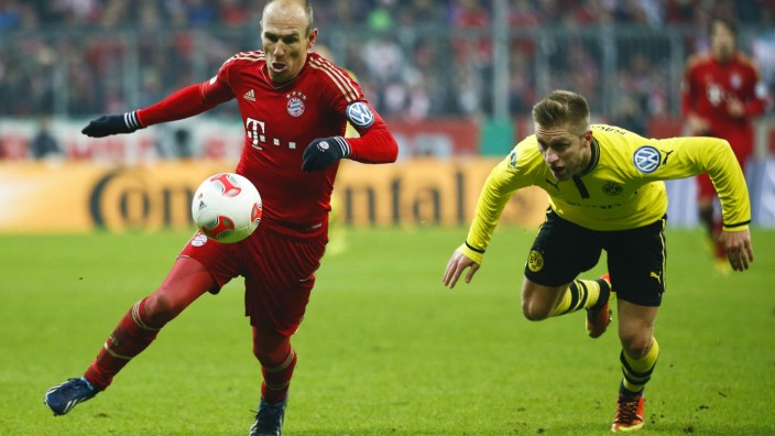 Bayern Munich's Robben is followed by Borussia Dortmund's Bender during their German soccer cup, DFB Pokal, quarter final match in Munich