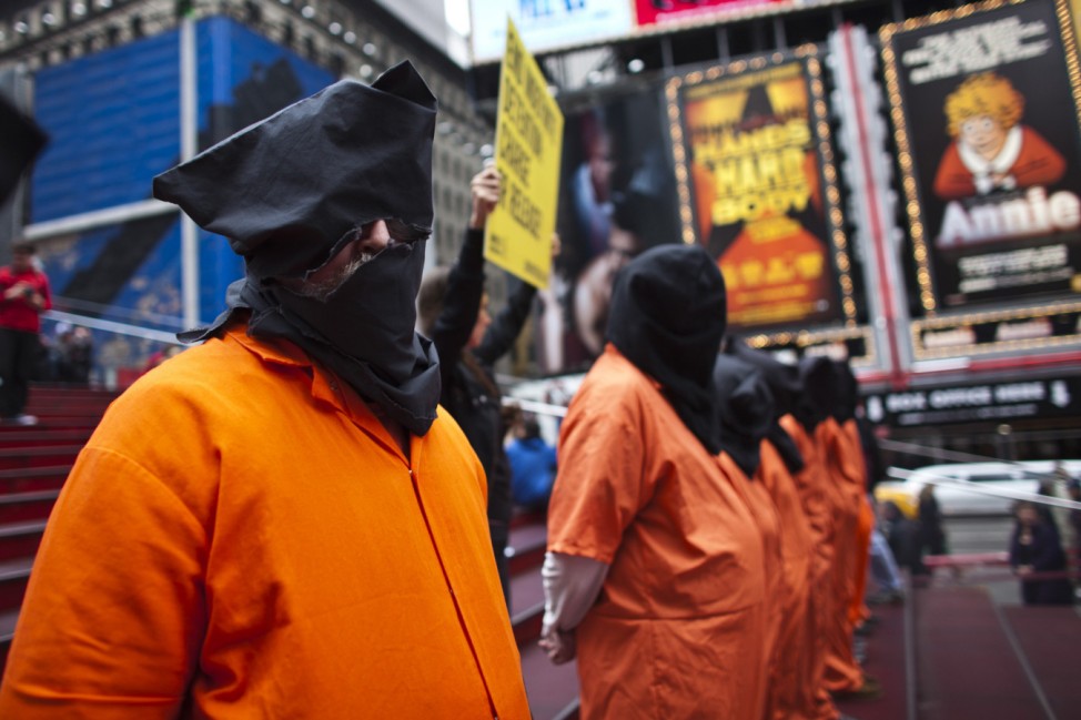 Activists dressed as prisoners demand the closure of the U.S. military's detention facility in Guantanamo Bay, Cuba while taking part in a protest in New York