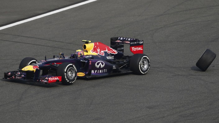Red Bull Formula One driver Mark Webber of Australia loses his rear wheel during the Chinese F1 Grand Prix at the Shanghai International Circuit