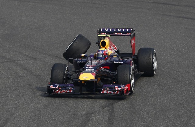 Red Bull Formula One driver Webber loses his rear wheel as he drives during the Chinese F1 Grand Prix at the Shanghai International Circuit