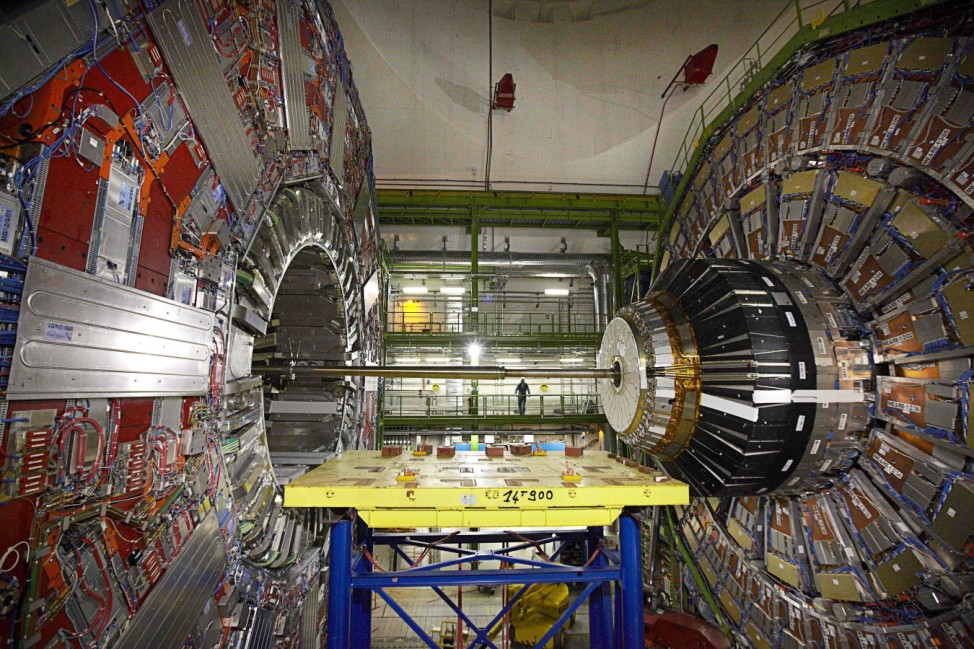 A technician stands near equipment of the CMS experience at the CERN in Cessy