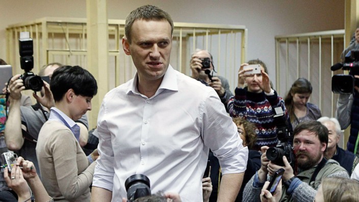 Russian opposition leader and anti-graft blogger Navalny looks on after arriving for a court hearing in Kirov