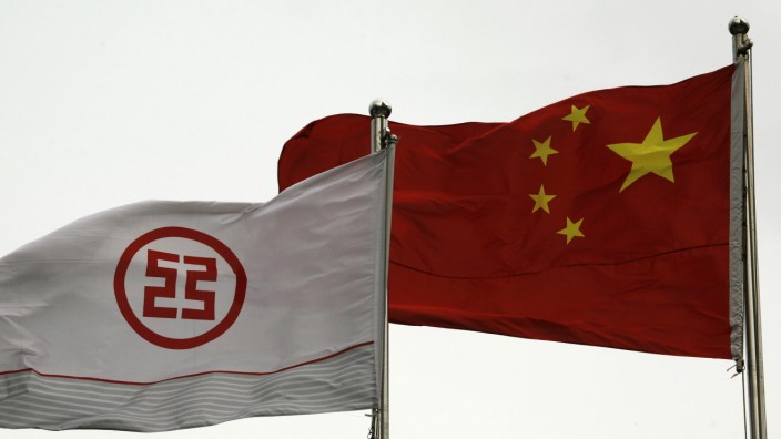 A flag printed with a logo of the Industrial & Commercial Bank of China flies along with a Chinese flag outside a branch in China's southern city of Shenzhen