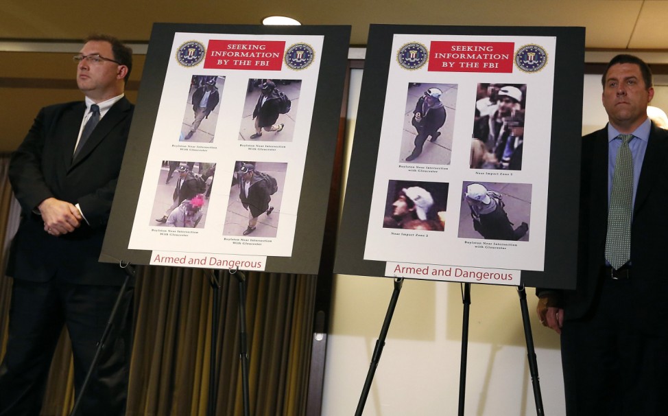 Photos of suspects in the Boston Marathon bombings are seen during a news conference in Boston, Massachusetts