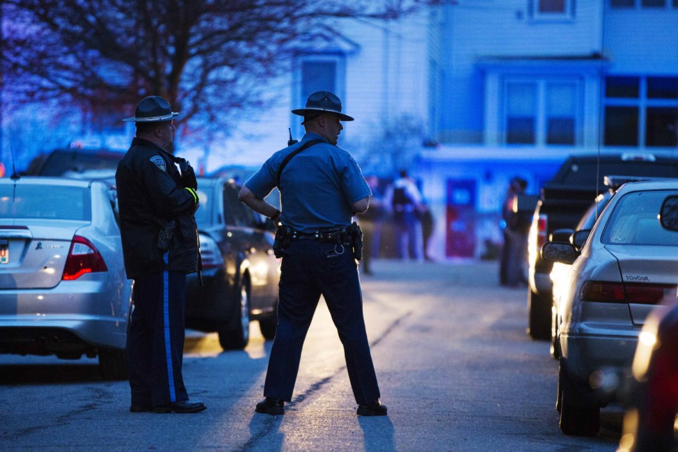 Law enforcement officials stand on Franklin St. as the search for Dzhokhar Tsarnaev, suspect in the Boston Marathon bombings, comes to an end in Watertown