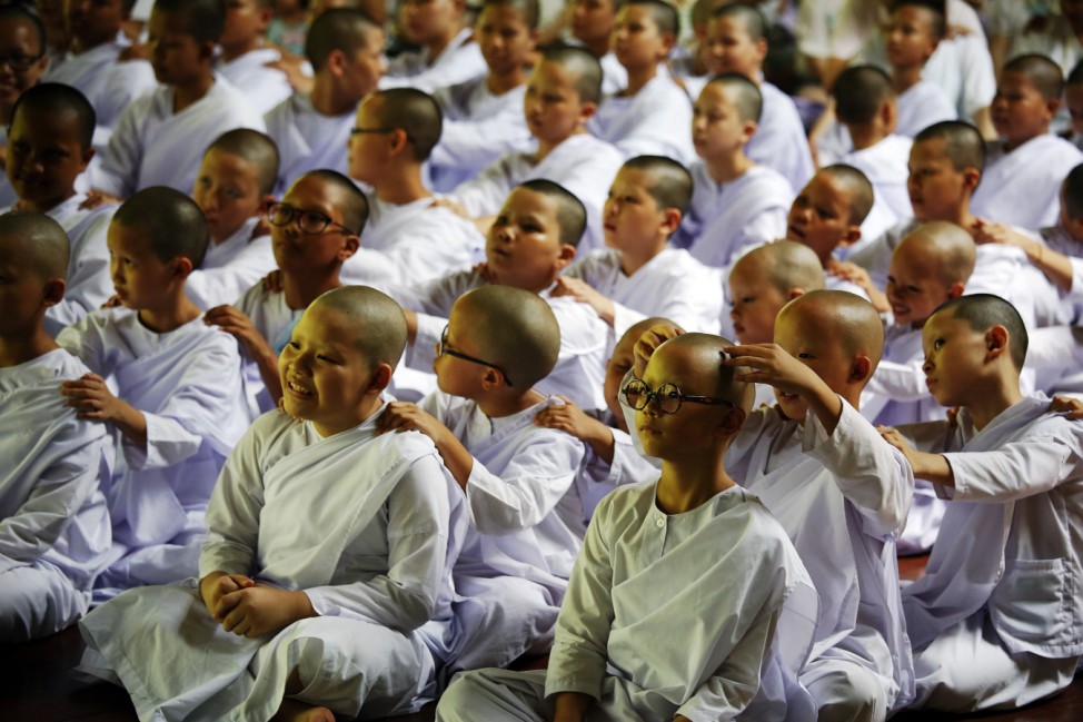 Novice nuns give each other a massage at the Sathira-Dhammasathan Buddhist meditation centre in Bangkok