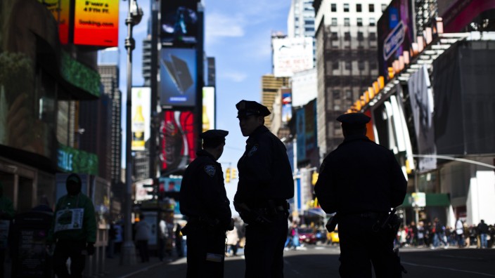 New York Police officers keep watch on tourists at Times Square in New York