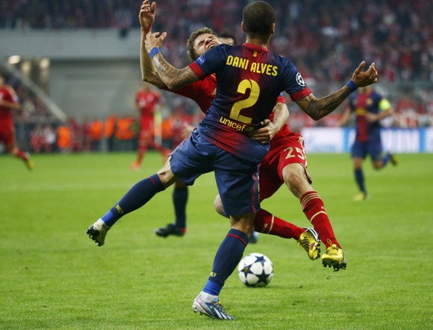 Bayern Munich's Thomas Muller is fouled by Barcelona's Daniel Alves during their Champions League semi-final first leg soccer match in Munich