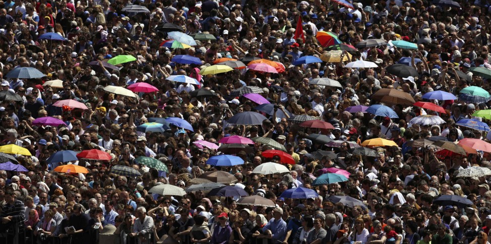 Faithful attend as Pope Francis leads a mass in Saint Peter's Square at the Vatican