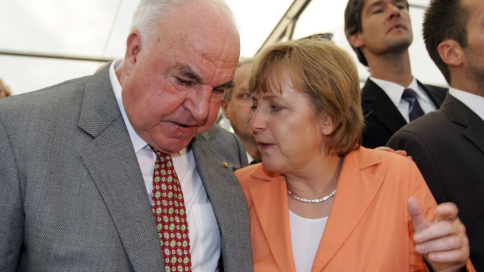 File photo of Merkel talking to former German Chancellor Kohl during a wine party in Bavarian town of Castell