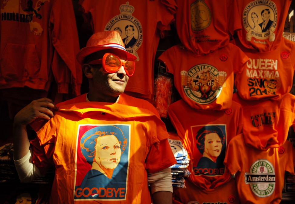 A man wearing shades displays a t-shirt depicting Dutch Queen Beatrix in a souvenirs shop in Amsterdam