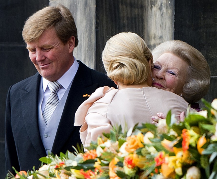 Princess Beatrix (R) of the Netherlands accompanied by her son King Willem-Alexander embraces Queen Maxima at the Royal Palace balcony in Amsterdam