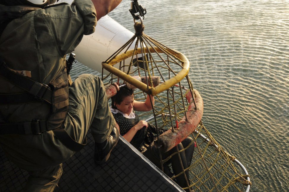 A passenger of a hot air balloon that crashed in the open sea, is rescued by a Peruvian Navy helicopter near Canete