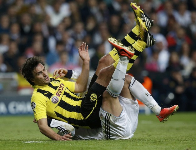 Borussia Dortmund's Mats Hummels and Real Madrid's Gonzalo Higuain fall during their Champions League semi-final second leg soccer match in Madrid