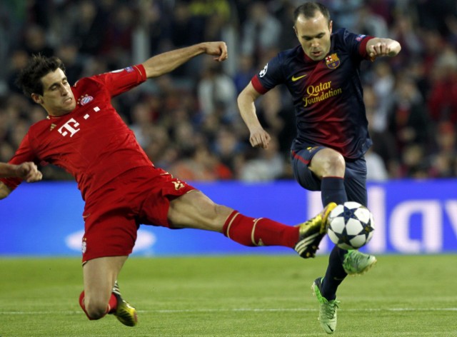 Bayern Munich's Martinez tackles Barcelona's Iniesta during Champions League semi-final second leg soccer match in Barcelona
