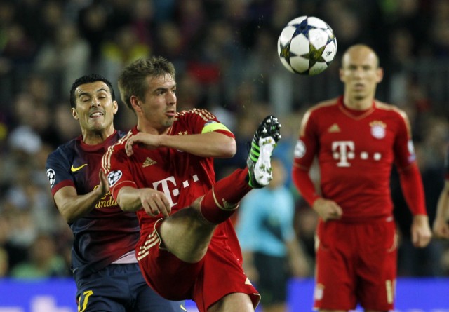 Bayern Munich's Robben watches as Lahm controls ball in front of Barcelona's Rodriguez during Champions League semi-final second leg soccer match in Barcelona