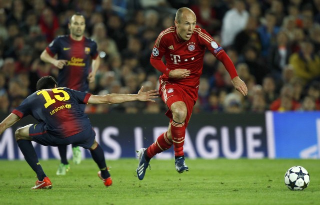 Bayern Munich's Robben is challenged by Barcelona's Bartra during their Champions League semi-final second leg soccer match at Camp Nou stadium in Barcelona