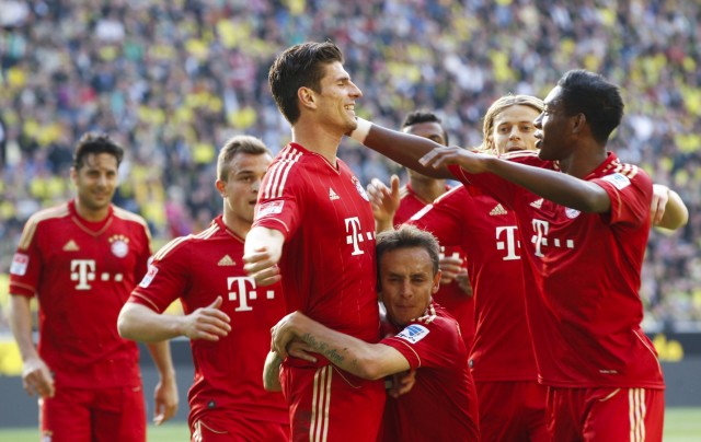 Bayern Munich's Gomez celebrates with team mates after he scored a goal against Borussia Dortmund during the German first division Bundesliga soccer match in Dortmund