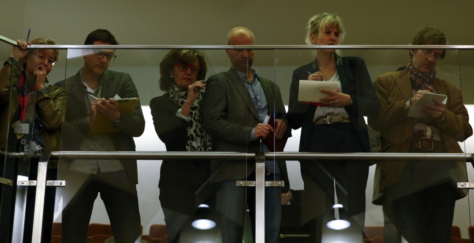 Journalists covering the trial of the neo-Nazi group National Socialist Underground (NSU) stand on a balcony in the courthouse before the start of the trial in Munich