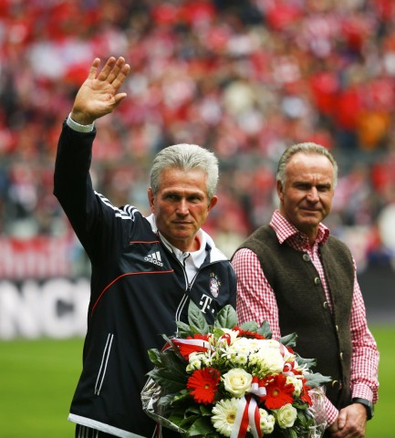 Bayern Munich's coach Heynckes waves next to former player Rummenigge, Chief Executive Officer of Bayern Munich, before the German first division Bundesliga soccer match between Bayern Munich and Augsburg in Munich