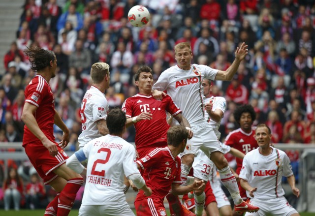 Bayern Munich's Mandzukic fights for the ball with Augsburg's Klavan during their German first division Bundesliga soccer match in Munich