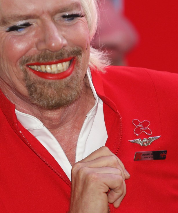 British entrepreneur Branson shows his nametag during an AirAsia promotional event in Sepang