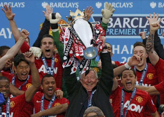 Manchester United manager Alex Ferguson lifts the English Premier League trophy at Old Trafford stadium in Manchester