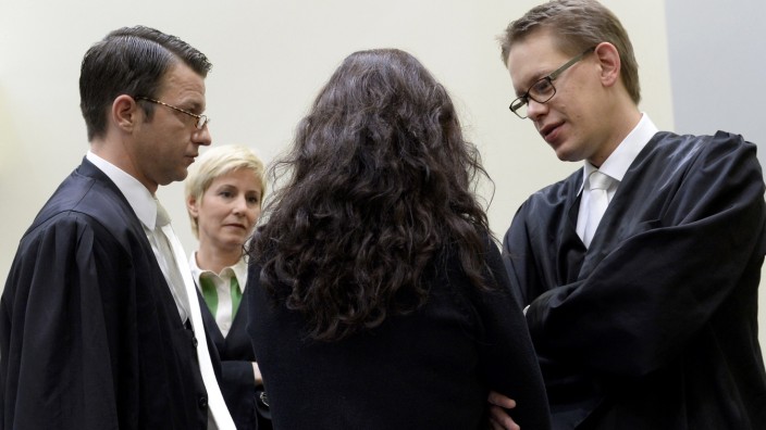 Defendant Beate Zschaepe speaks with her lawyers before the third session of her trial in the courtroom in Munich