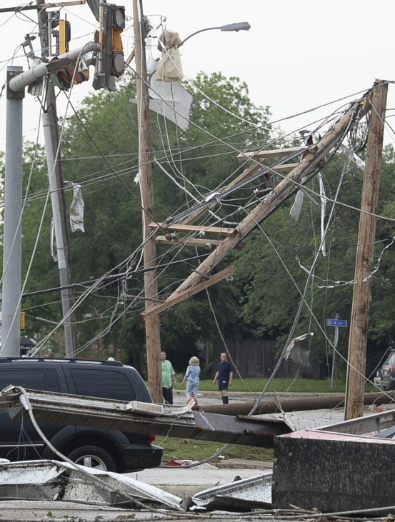 Power poles and lines lie tangled after a tornado struck Moore, Oklahoma