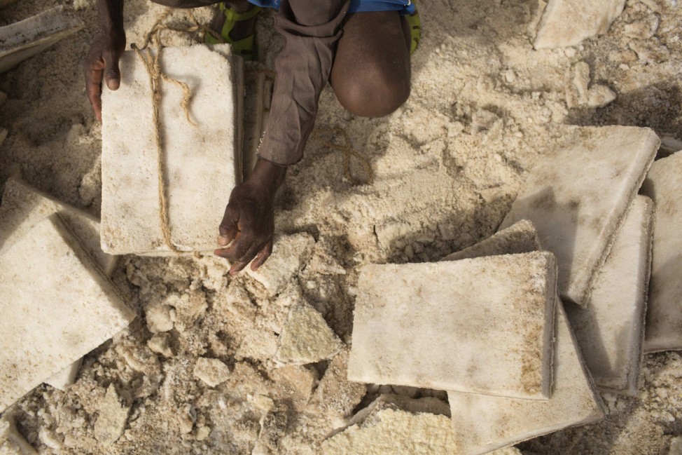 A worker ties together slabs of salt extracted from the Danakil Depression in northern Ethiopia