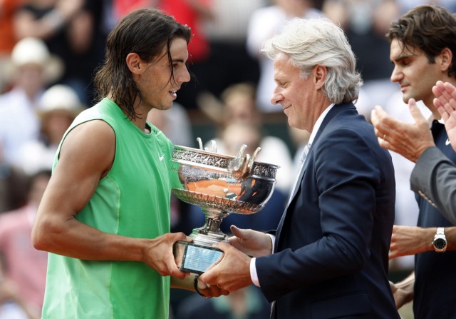 Spain's Nadal receives his trophy from former Swedish tennis champion Borg at French Open tennis tournament at Roland Garros in Paris