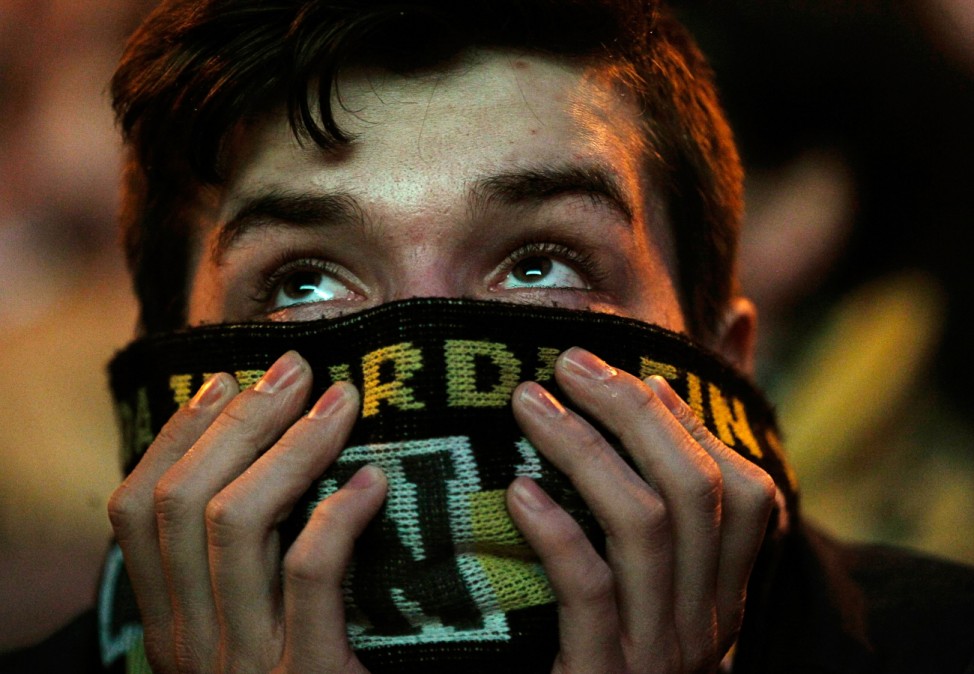 A Borussia Dortmund soccer fan reacts at a public viewing event in Dortmund