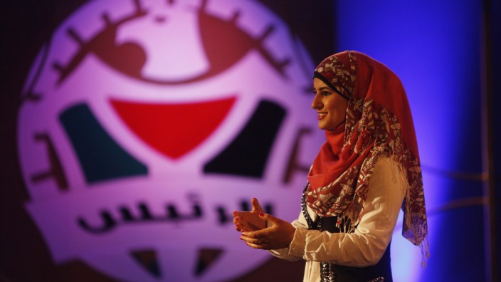 A contestant stands in front of judges during taping of 'The President' game show in Ramallah