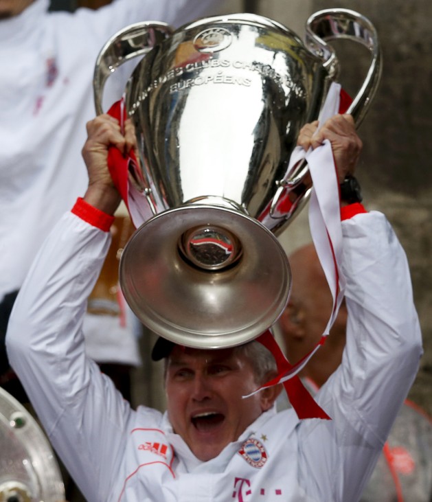 Bayern Munich's coach Jupp Heynckes holds up the Champions League trophy on the balcony of the town hall in Munich