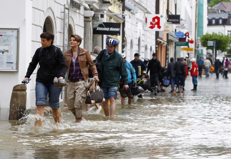 People walk through the flooded centre of Passau