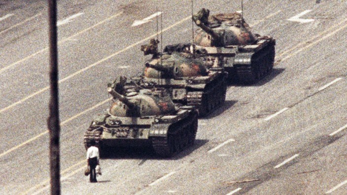 File photo of a man standing in front of a convoy of tanks in the Avenue of Eternal Peace in Beijing
