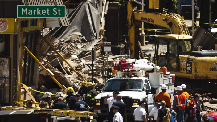 Rescue workers search through rubble following a building collapse in Philadelphia