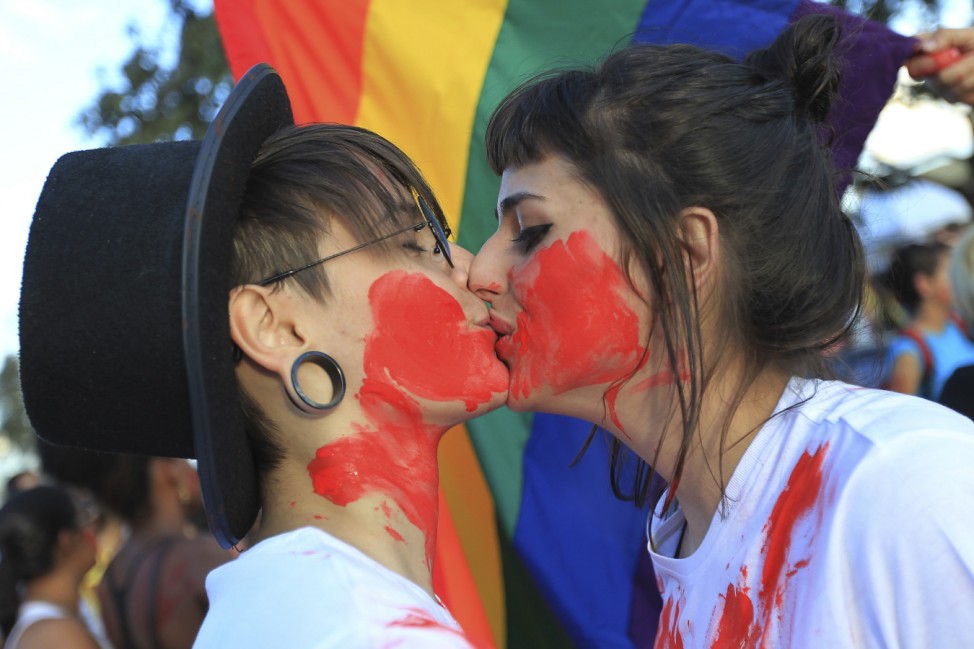 A couple kisses in protest at the 'March For Family' demonstration against abortion and gay marriage, in front of the National Congress in Brasilia