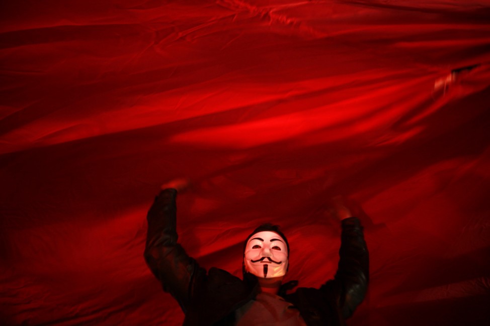 An anti-government protester holds up a big Turkish flag during a demonstration in Ankara